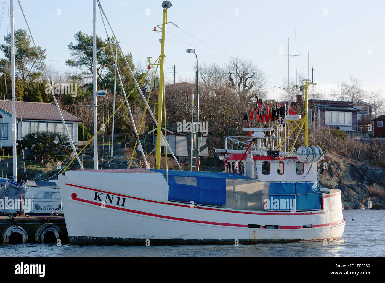 Karlshamn, Sweden - February 04, 2016: A small fishing boat is moored at the docks of a fishing harbor. Fishing regulations make Stock Photo