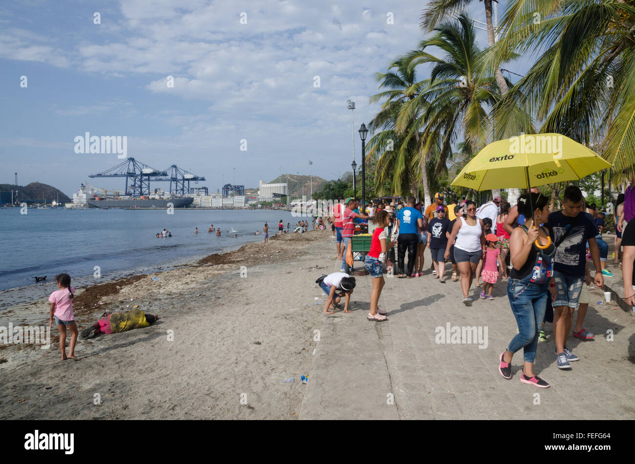 Tourists and locals strolling along the seafront in Santa Marta on the Caribbean coast of Colombia Stock Photo