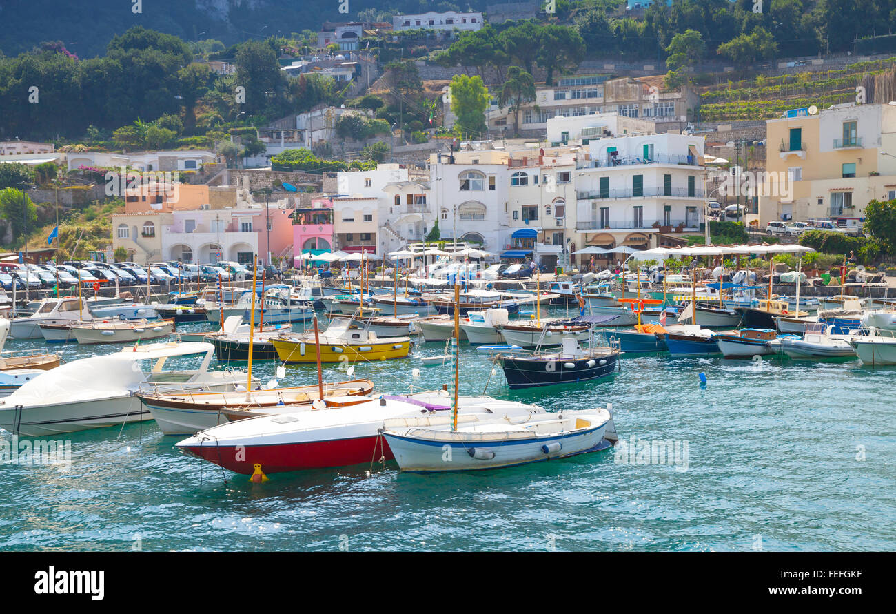 Port of Capri island, Italy. Colorful houses and moored pleasure motorboats Stock Photo
