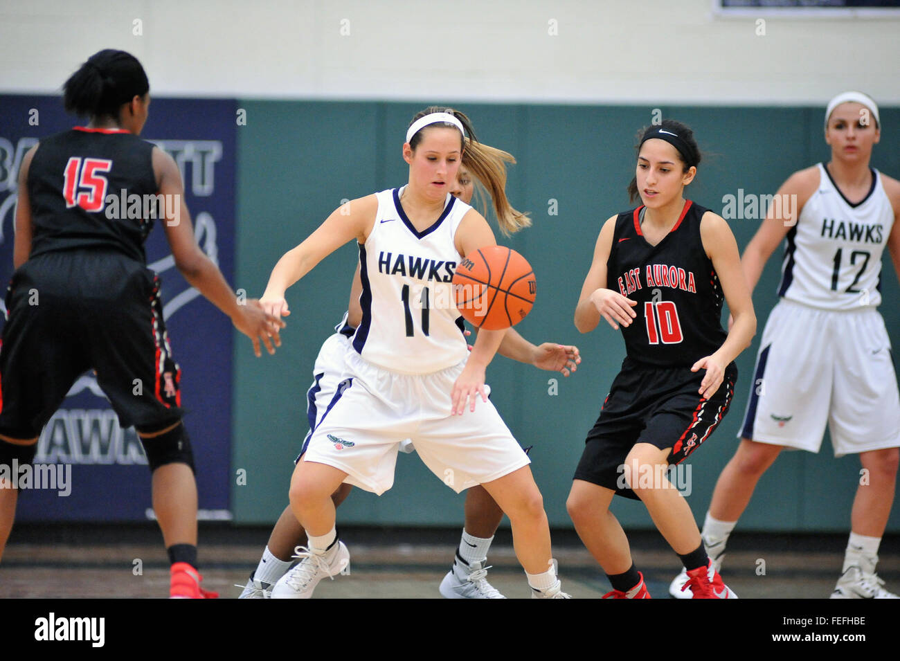 While defending her basket a high school player is totally focused on the ball after creating a turnover. USA. Stock Photo