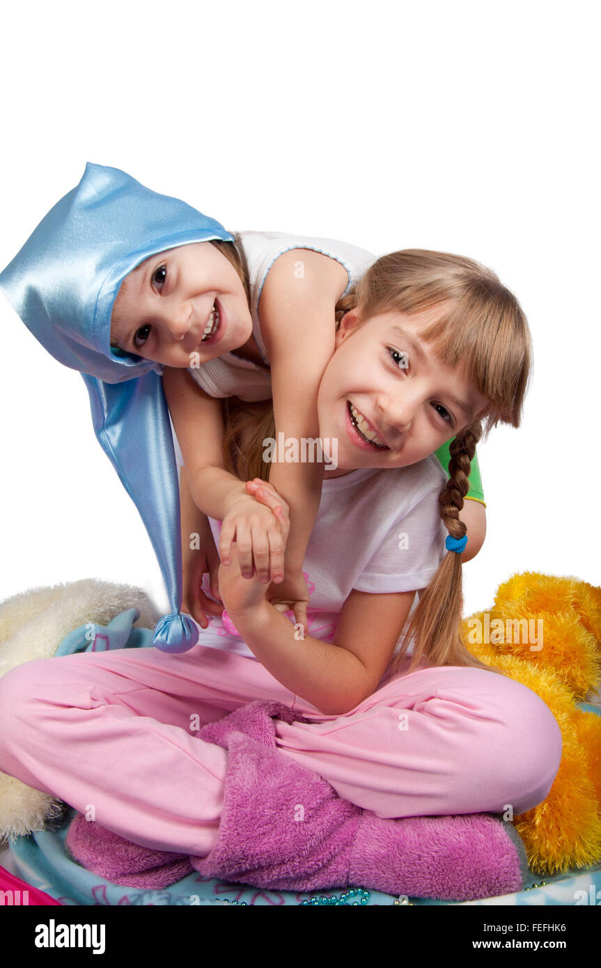 Cute girls in pink pajamas smiling isolated on white Stock Photo Alamy