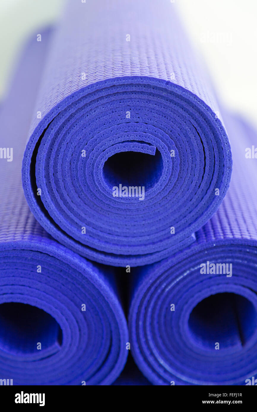Pile of purple Yoga or Pilates Mats Stock Photo