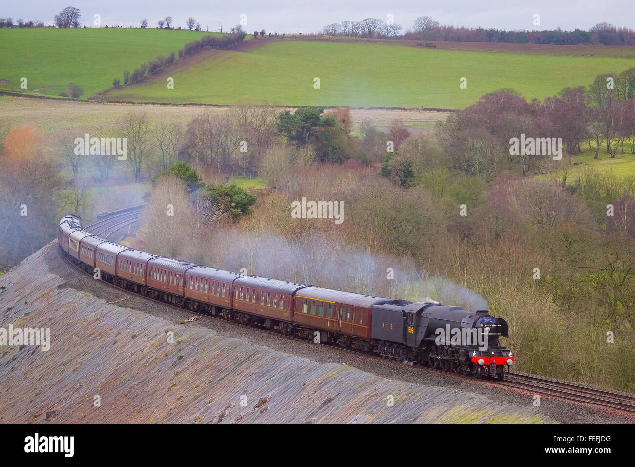 Cumbria, UK. 6th Feb, 2016. Armathwaite, Settle to Carlisle Railway Line UK. Steam train LNER A3 Class 4-6-2 no 60103 'Flying Scotsman'. The Winter Cumbrian Mountain Express. Its inaugural mainline run for 10 years. Near Low Baron Wood Farm at this time, running 49 minutes late at this time run due to engineering work on the line. Credit:  Andrew Findlay/Alamy Live News Stock Photo
