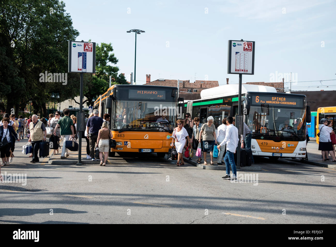 Workers heading to their workplaces at the main Venice bus terminal at Piazzale Roma next to the Canale Grande (Grand Canal) in Venice, northern Italy Stock Photo