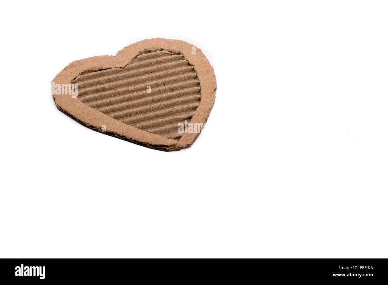 Heart shape cut out of a cardboard paper Stock Photo
