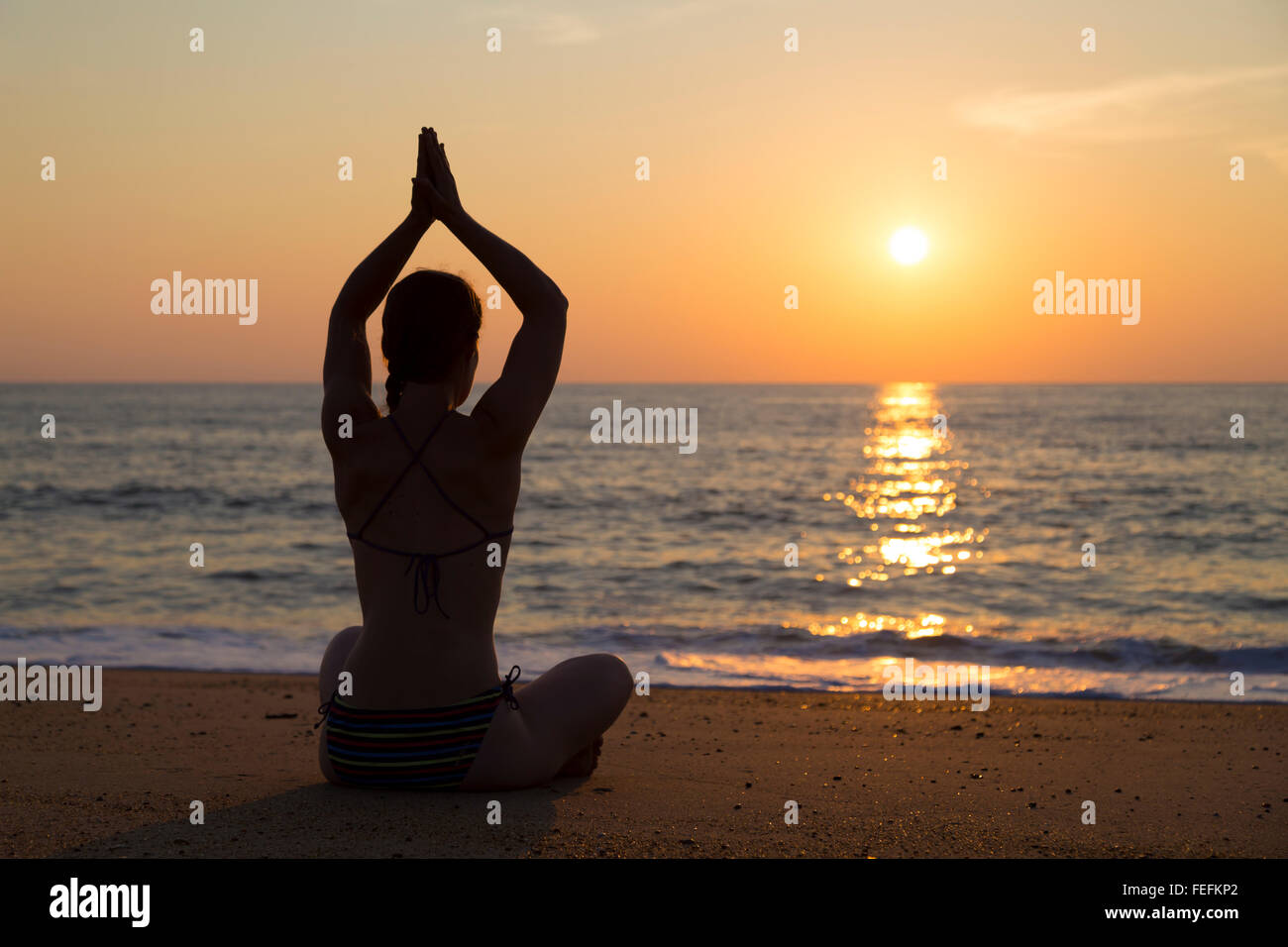 Sunset yoga on the beach Stock Photo Alamy