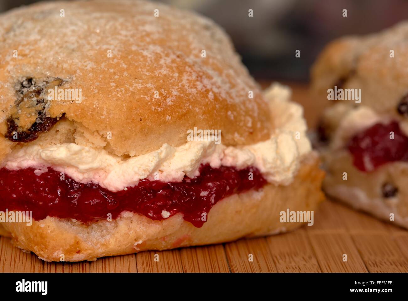 A fruit scone with strawberry jam and fresh cream in side Stock Photo