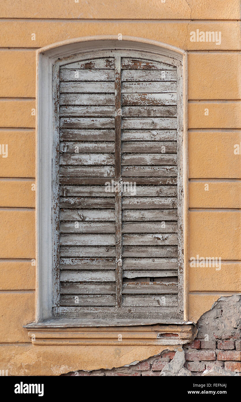 Old weathered wall and window. Window frame. Stock Photo