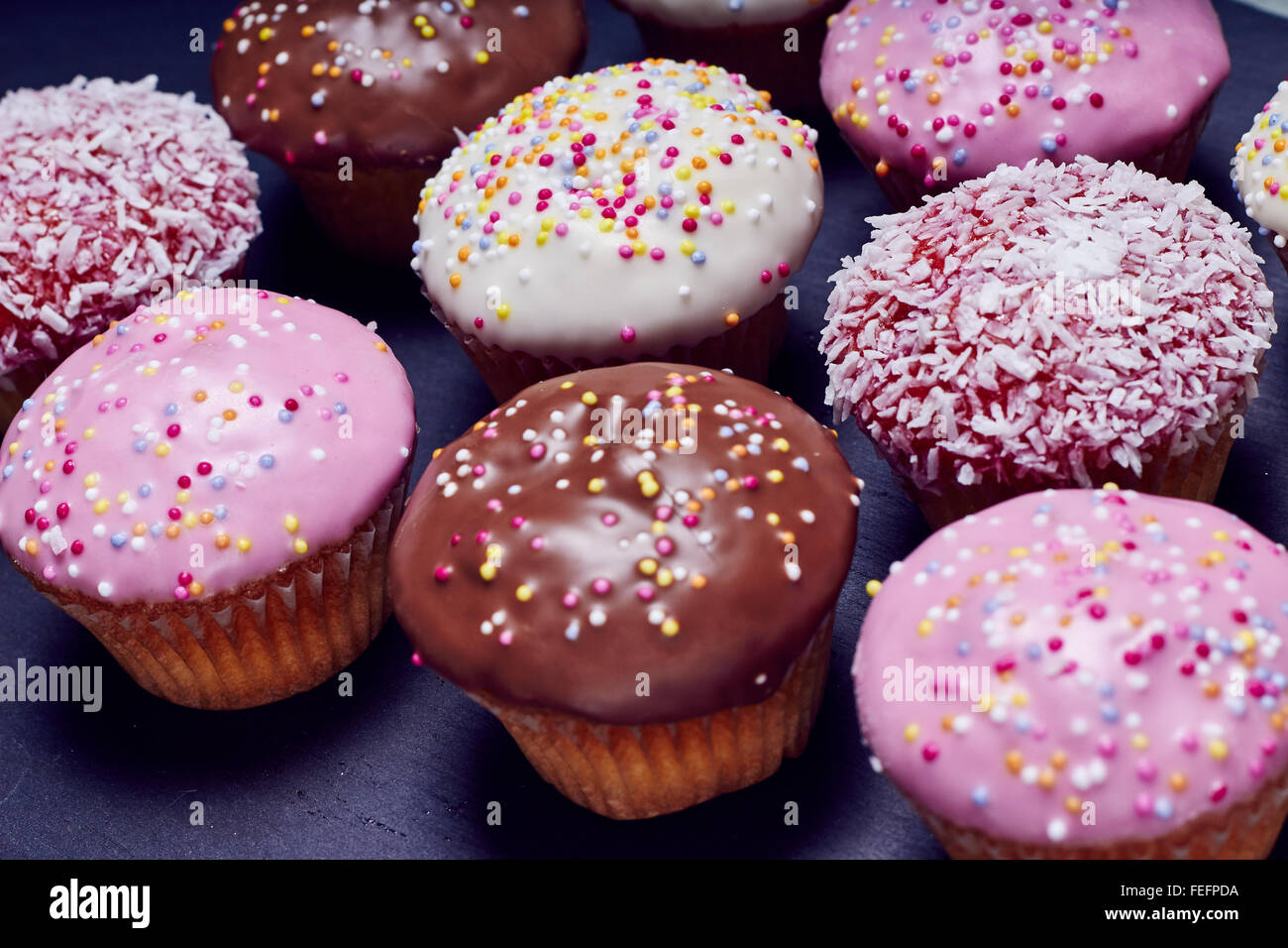 Top view showing many cupcakes in different colors Stock Photo - Alamy