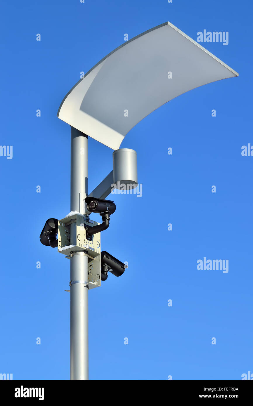 Surveillance cameras and modern lighting fixtures on the lamppost Stock