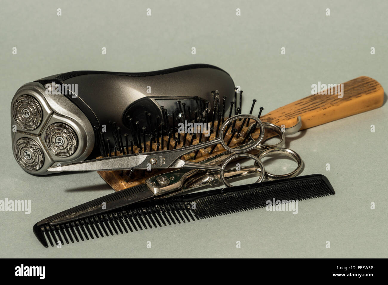 concept grooming devices including comb scissors electric shaver and brush Stock Photo