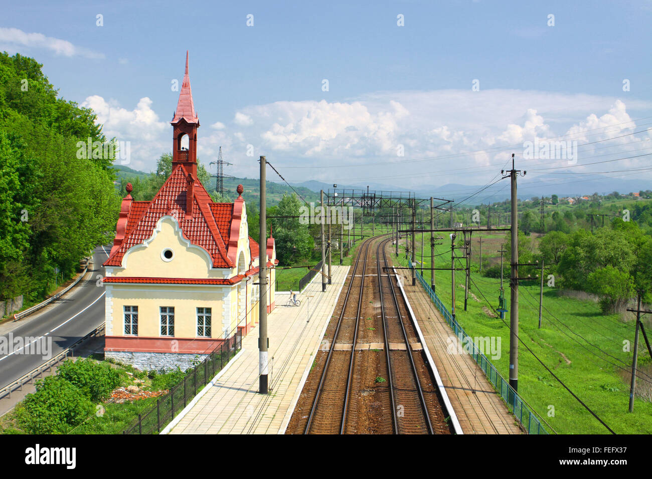 Railway tracks and small railway station in Carpathian mountains, Ukraine Stock Photo
