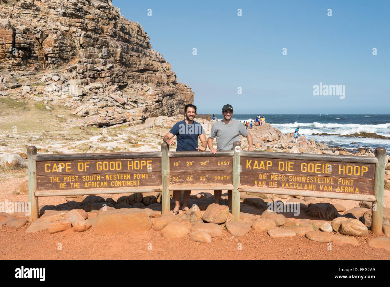 Male tourists by Cape of Good Hope sign, Cape Peninsula, City of Cape Town, Western Cape Province, Republic of South Africa Stock Photo