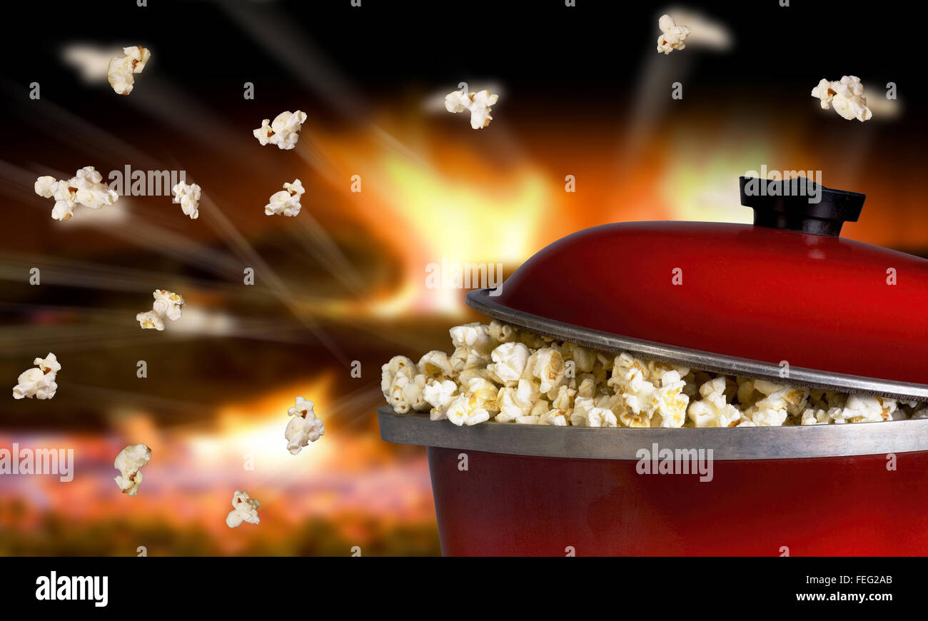 Popping popcorn the old fashion way in a red iron pot Stock Photo Alamy