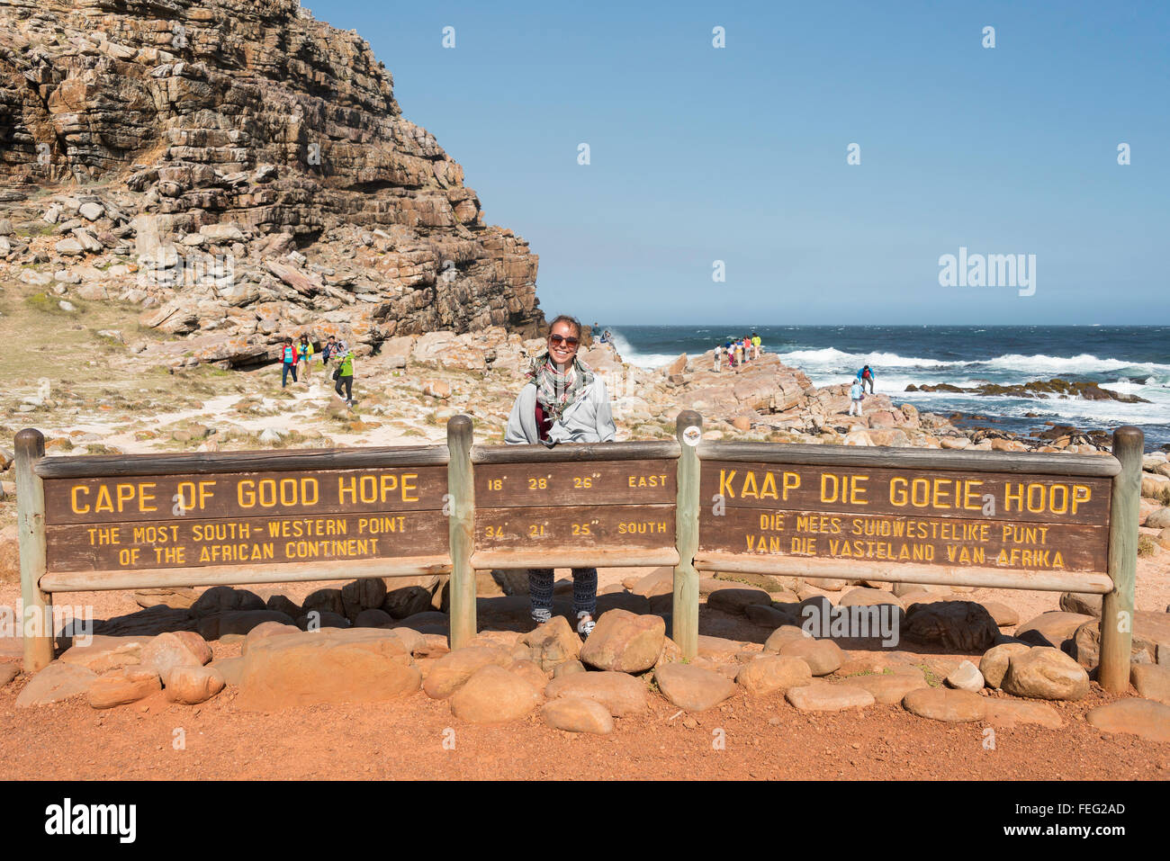 Female tourist by Cape of Good Hope sign, Cape Peninsula, City of Cape Town, Western Cape Province, Republic of South Africa Stock Photo