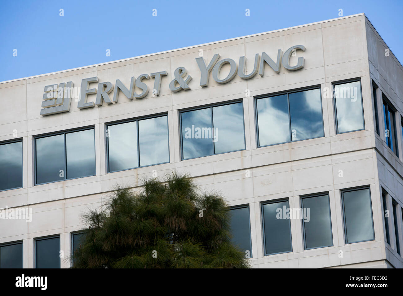 A logo sign outside of a facility occupied by Ernst & Young in Redwood City, California on January 24, 2016. Stock Photo
