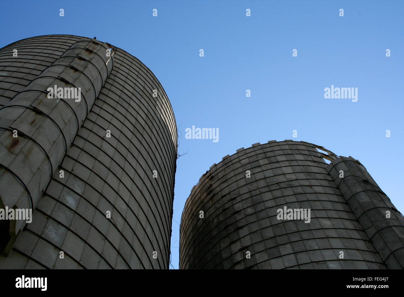 Towering silos against the blue sky Stock Photo - Alamy