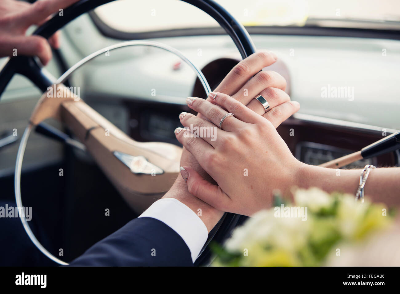 hands of the groom and the bride on a wheel of retro cars Stock Photo ...