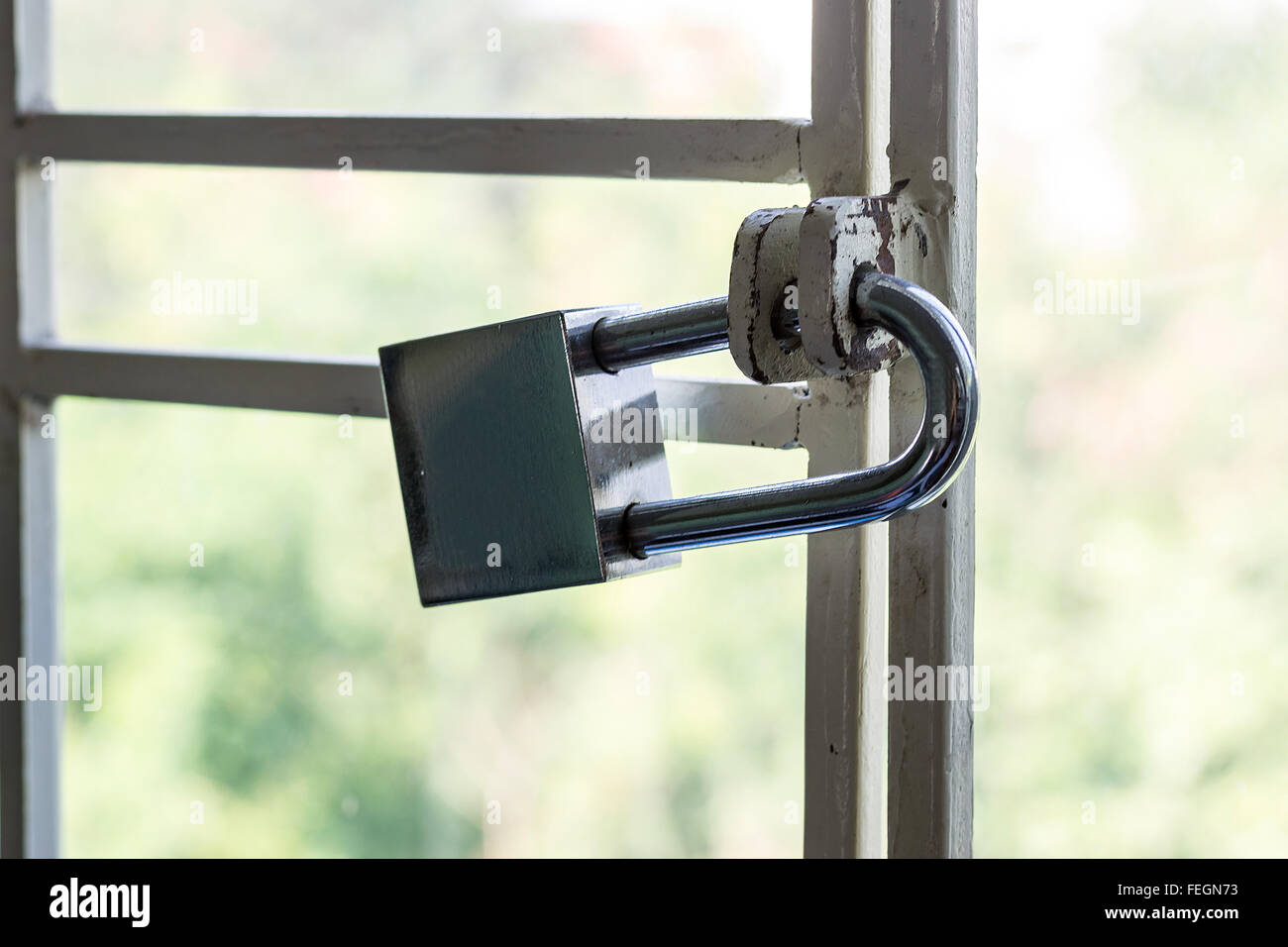The large lock padlock on the cage bottom of the window to prevent theft. Stock Photo