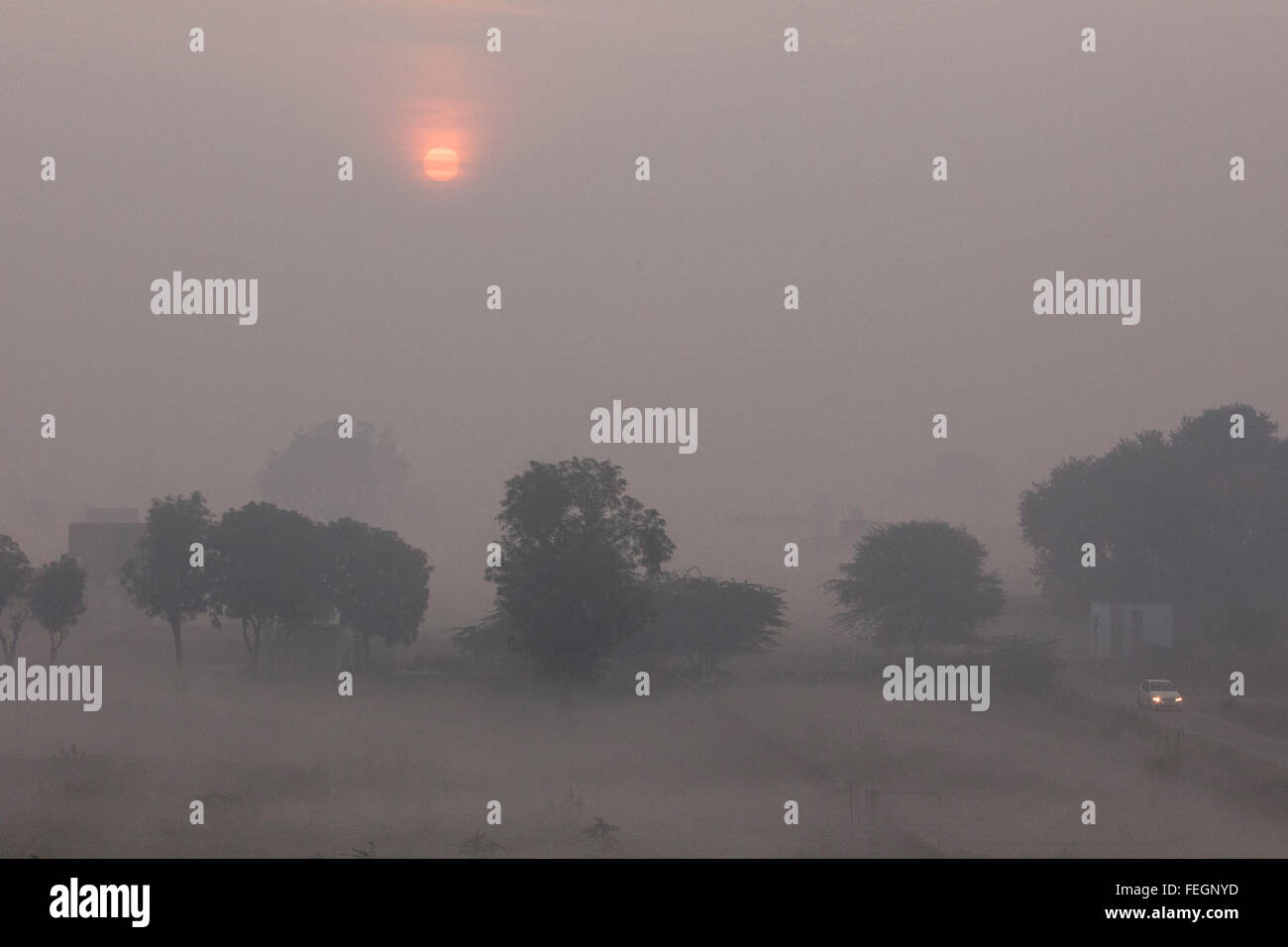 Early morning in Agra, India. The sun can be seen through an atmosphere of pollution and cloudy conditions. Stock Photo