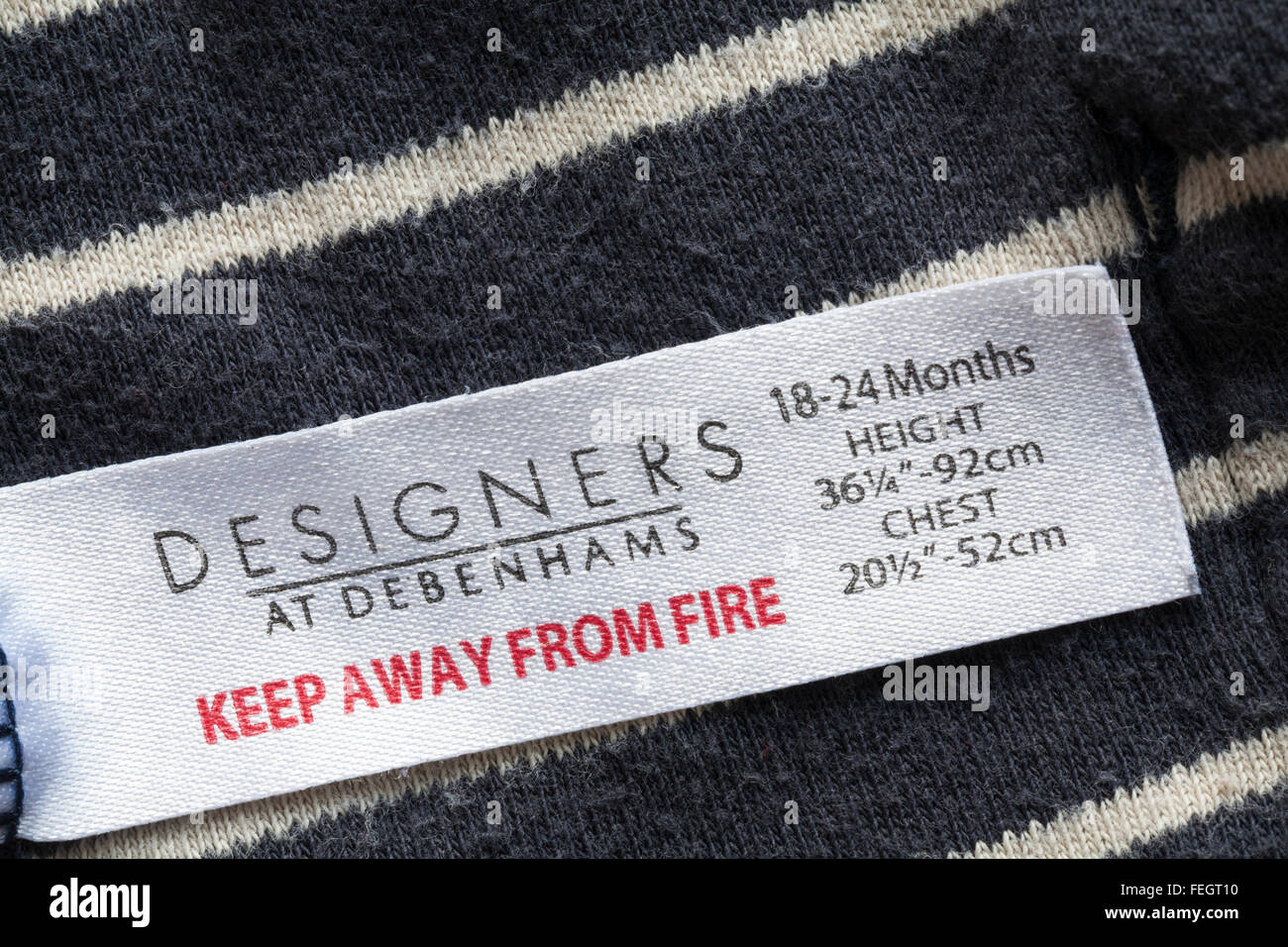Keep away from fire label in Designers at Debenhams garment for 18-24  months Stock Photo - Alamy