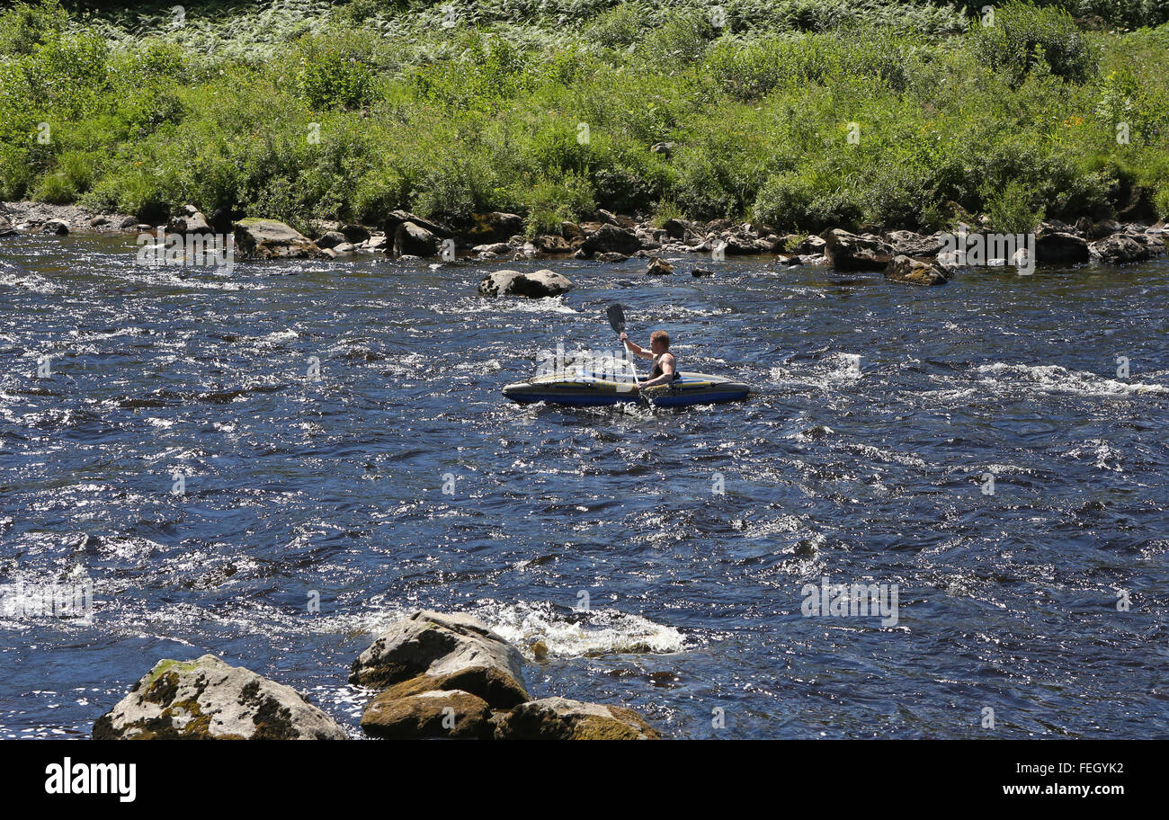 A kayaker on the river Dee near the village of Banchory, Aberdeenshire, Scotland, uk. Stock Photo