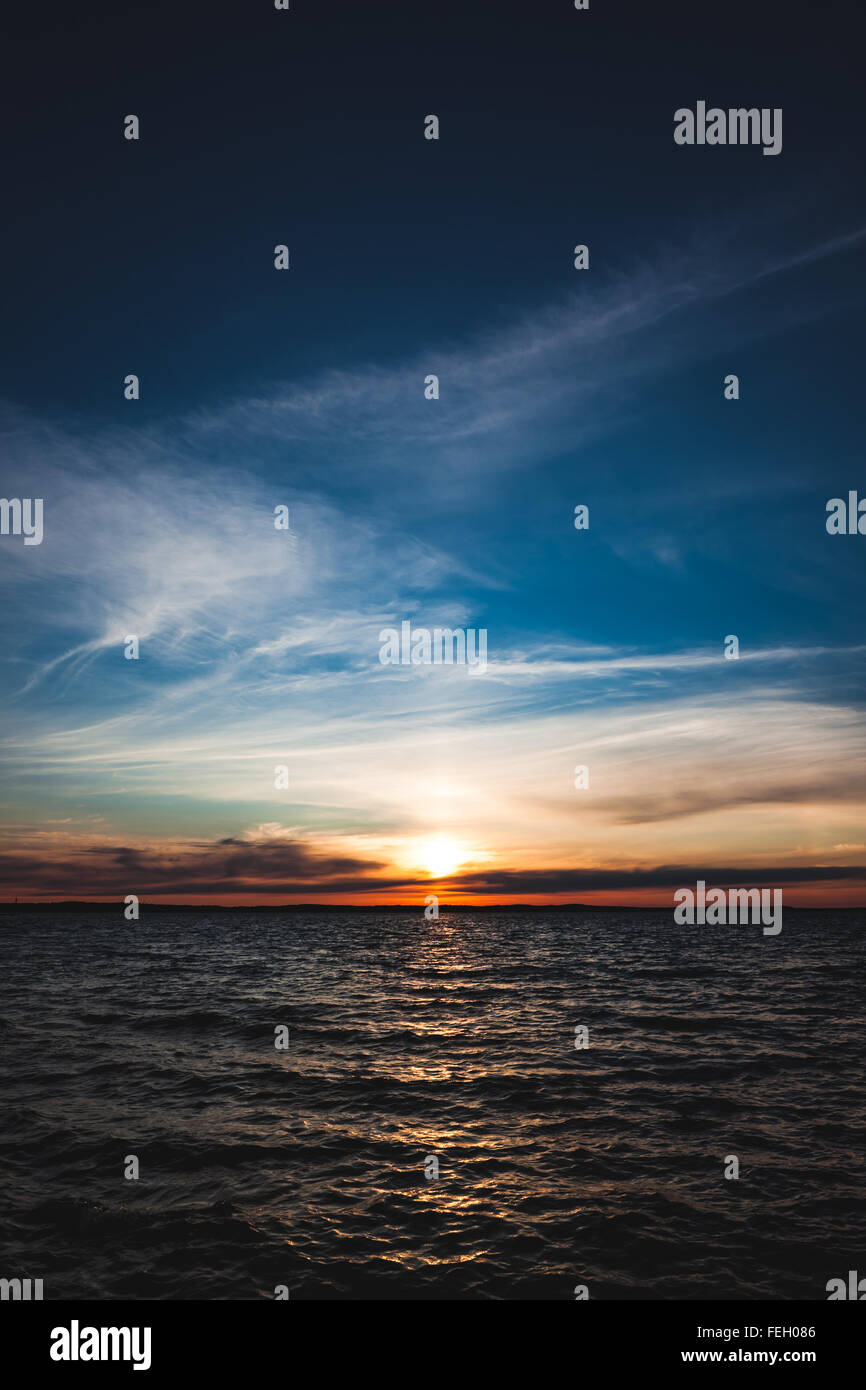 Calm sunset and clouds over lake Stock Photo - Alamy