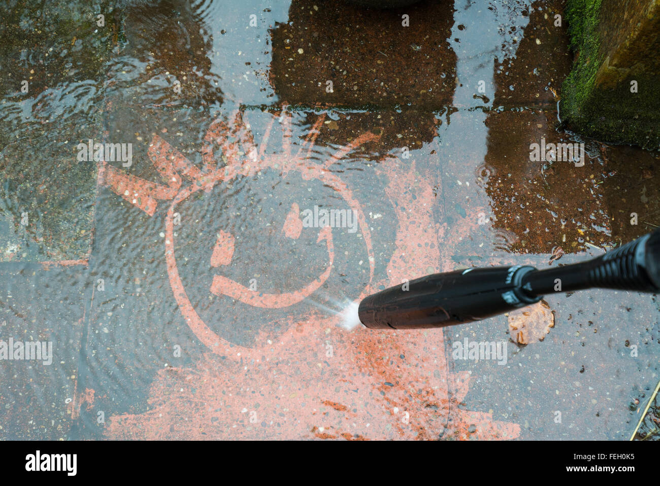 cleaning a dirty patio using a power wash Stock Photo