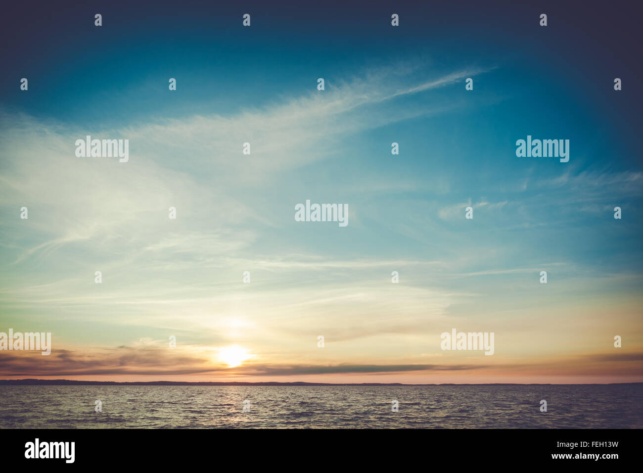 Calm sunset and clouds over lake Stock Photo - Alamy