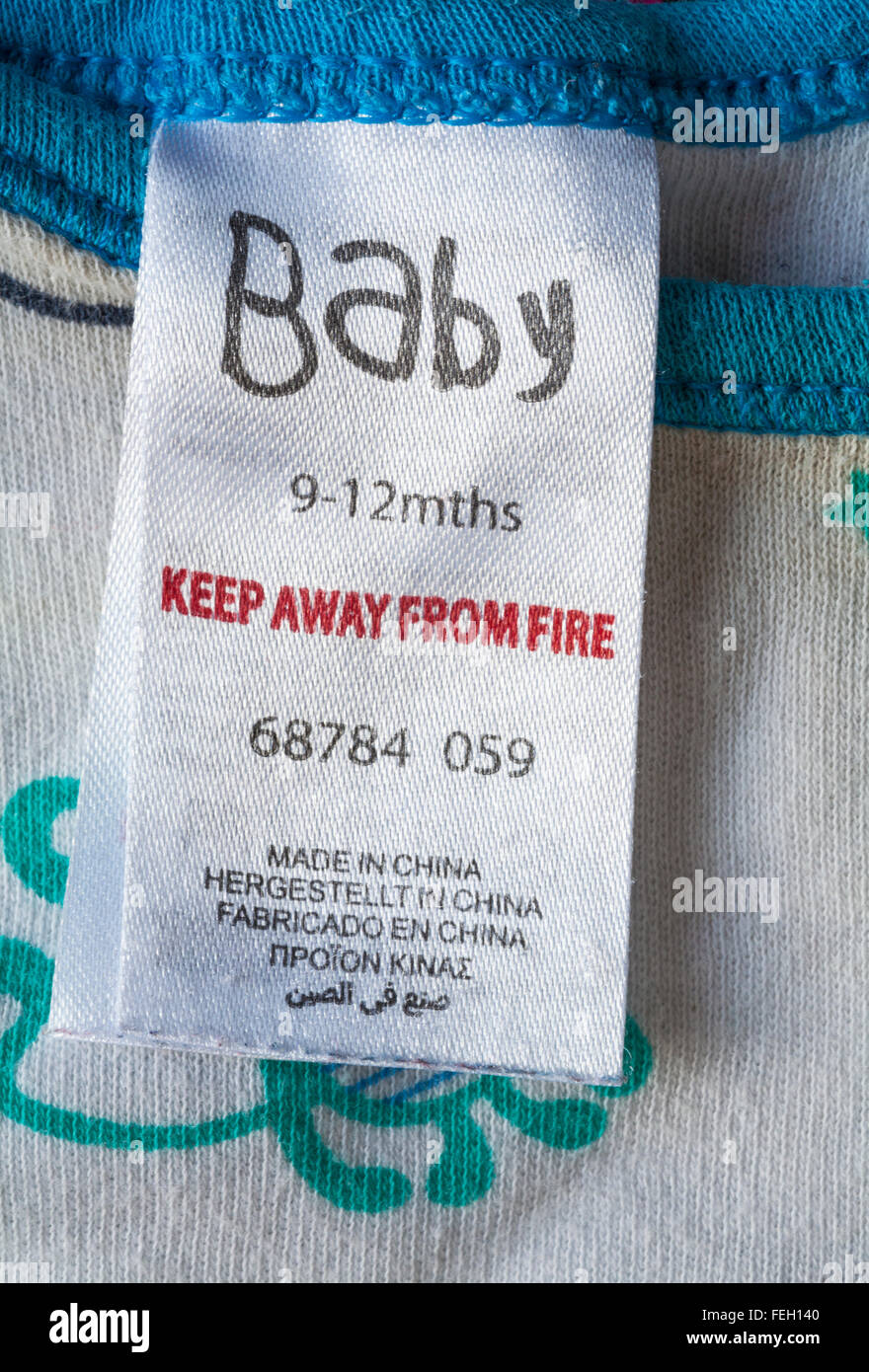 Keep away from fire label in Baby baby grow garment for 9-12 mths made in China - sold in the UK United Kingdom, Great Britain Stock Photo