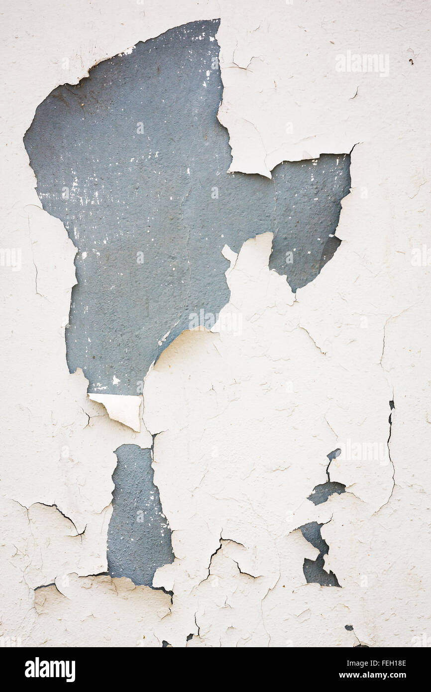 Old flaky white paint peeling off of a wall Stock Photo
