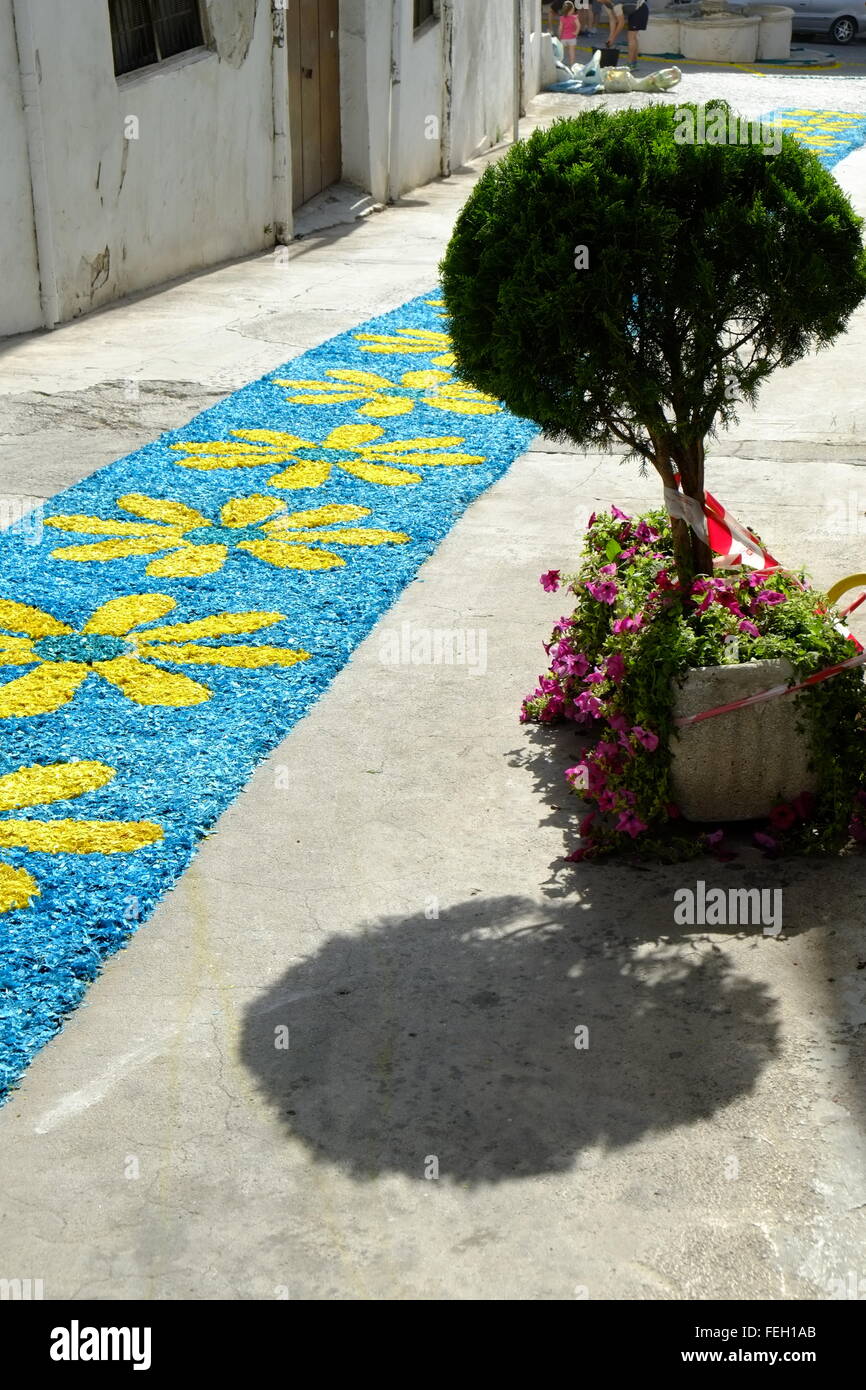 Corpus Christi. Patterned carpets of colour-dyed sawdust are laid by the whole community in the streets of the town. Carcabuey, Spain Stock Photo