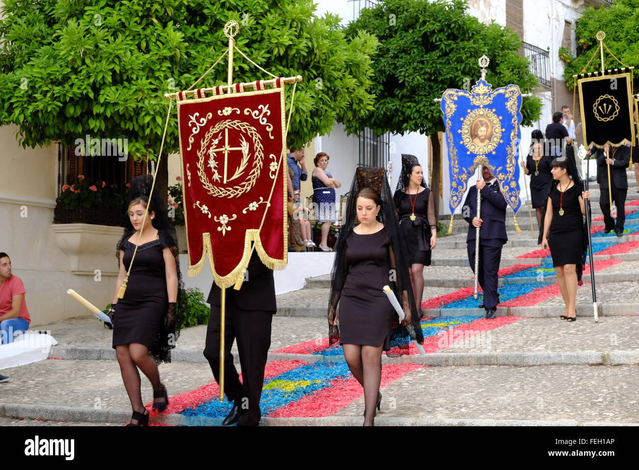 Corpus Christi procession on carpets of coloured wood chippings laid down on the streets of Carcabuey, Cordoba Province, Andalusia, Sapin Stock Photo