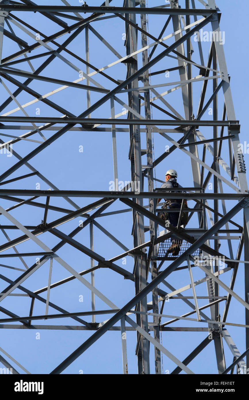Working at height on a transmission mast. Stock Photo
