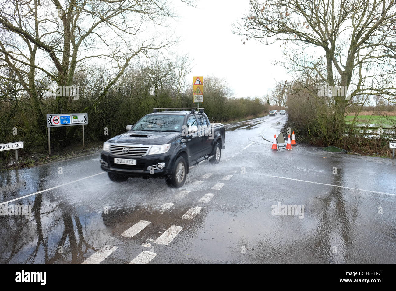 Cars drive along a flooded slash lane in mountsorrel Stock Photo Alamy