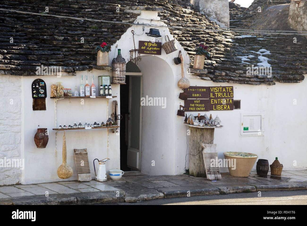 Typical trulli in Alberobello, Puglia, Italy - shop with signs in different languages Stock Photo