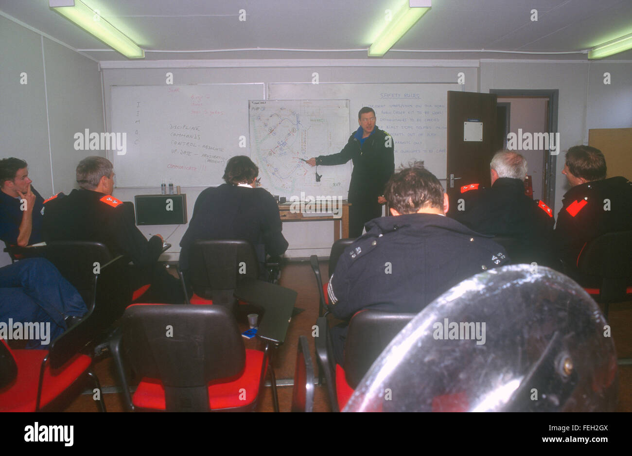 Police officers receiving briefing at Metropolitan Police Public Order Training Centre, London, UK. Stock Photo
