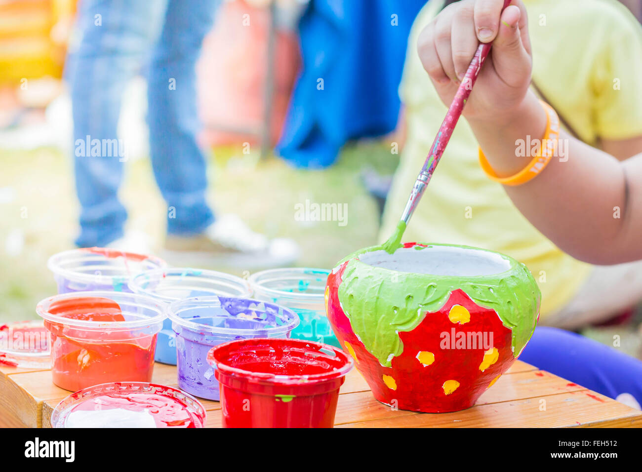Children who are using the paint brush. Stock Photo
