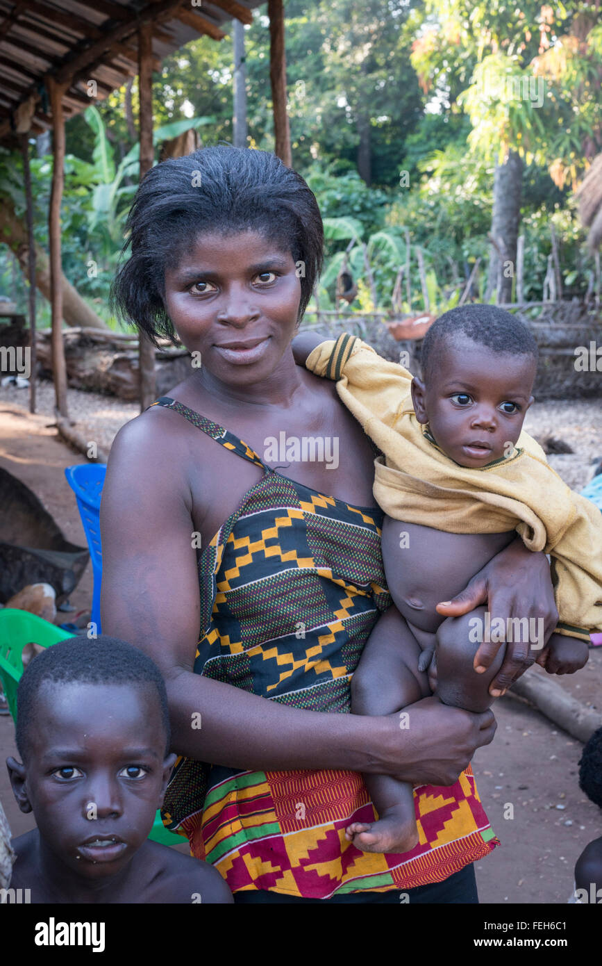A mother and her children in the  village of Agande on Uno island on the Bijagos archipelago in Guinea Bissau Stock Photo