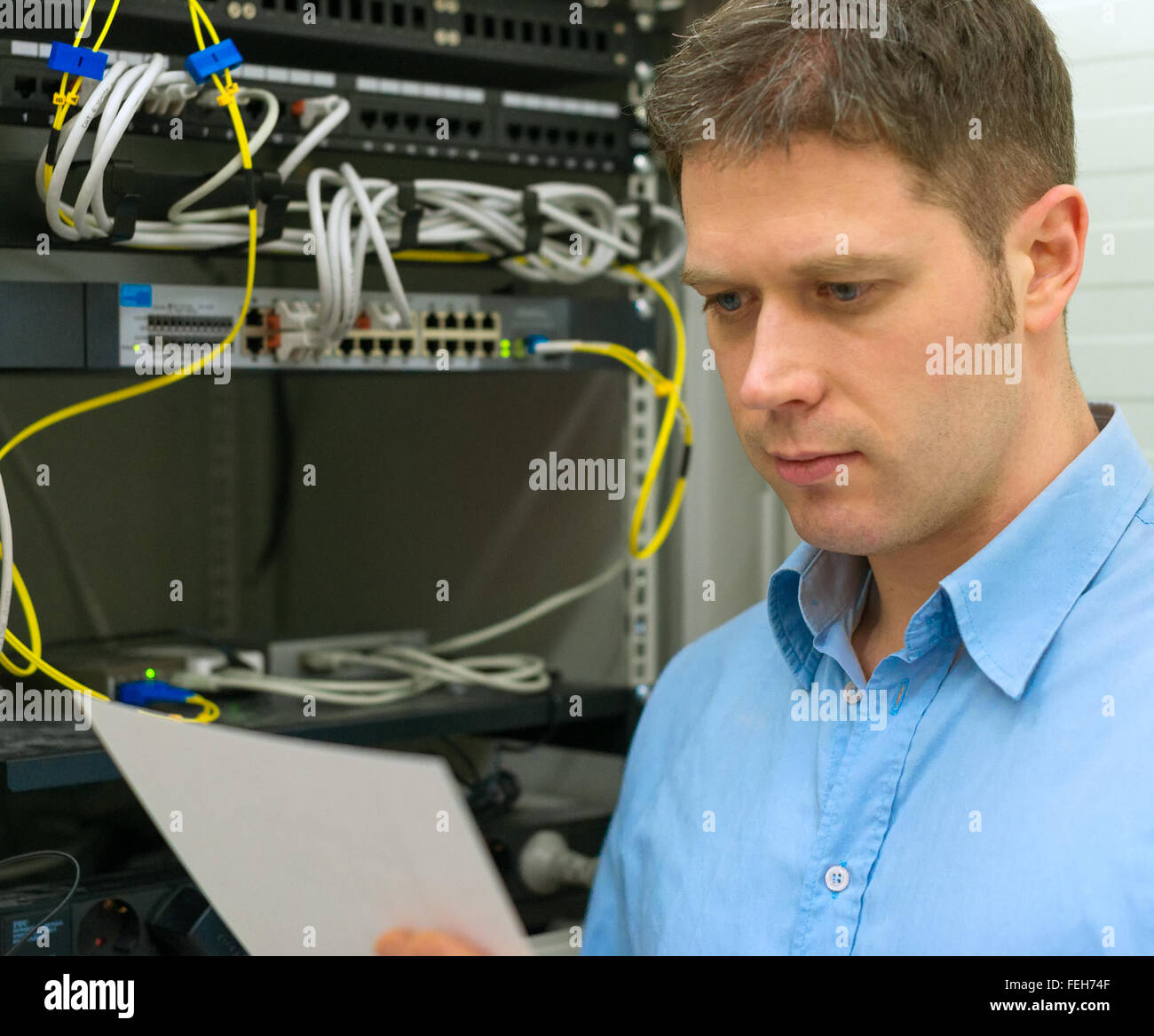 Network administrator with manual in server room Stock Photo Alamy