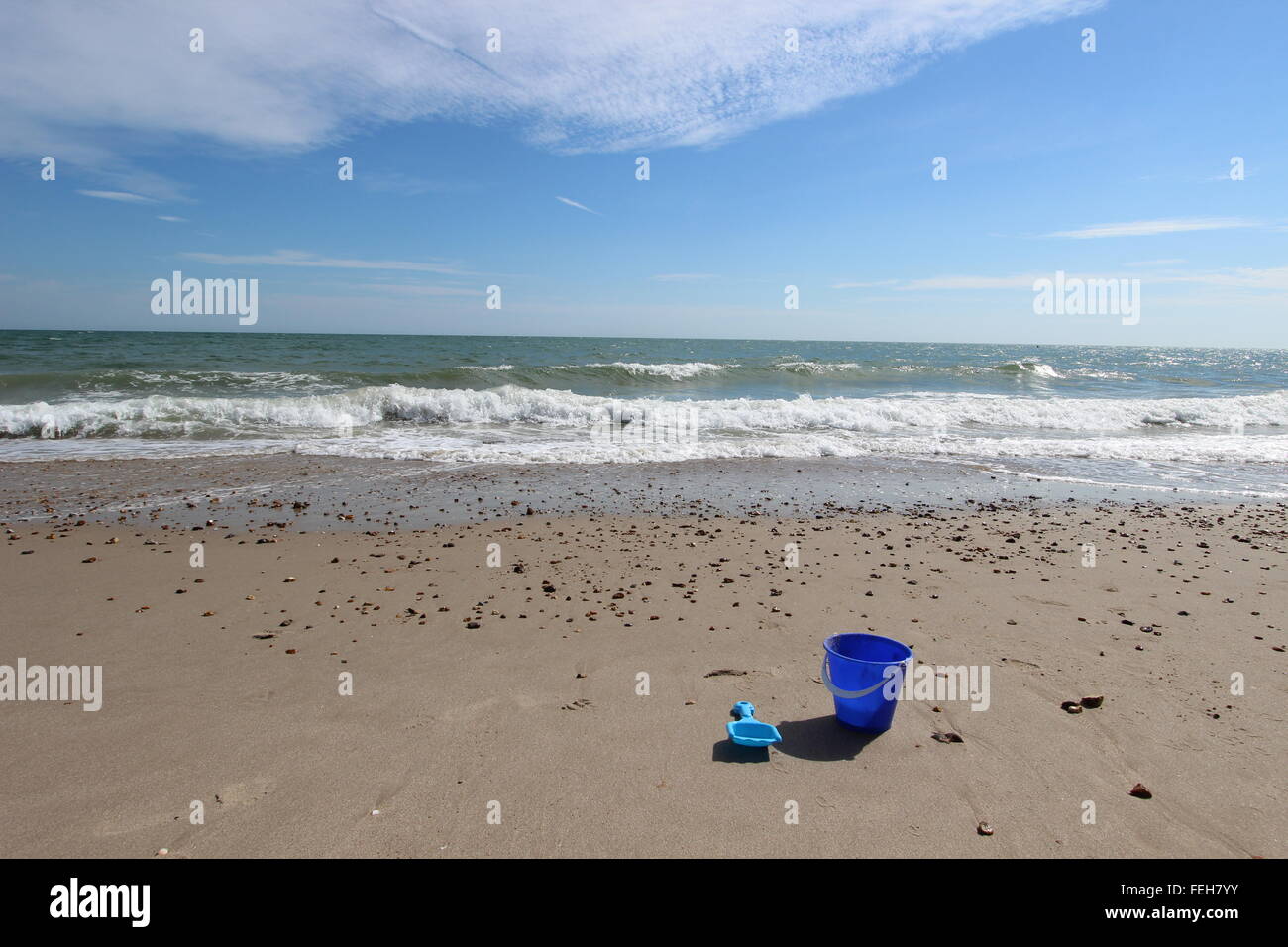 Blue bucket and spade on beach Stock Photo Alamy