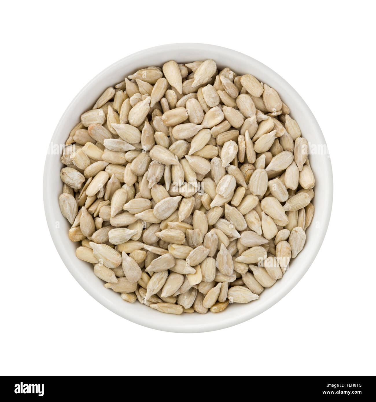 Sunflower Seeds in a Ceramic Bowl. The image is a cut out, isolated on a white background. Stock Photo