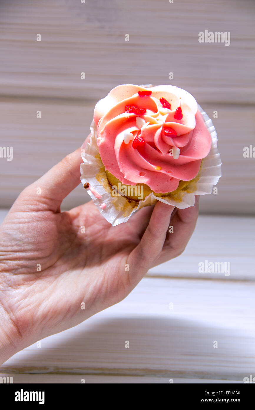 Female hand holding cupcake hires stock photography and images Alamy