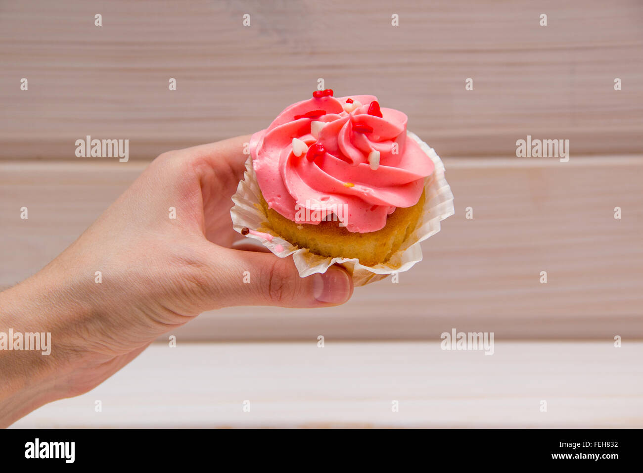 Female hand holding cupcake hires stock photography and images Alamy