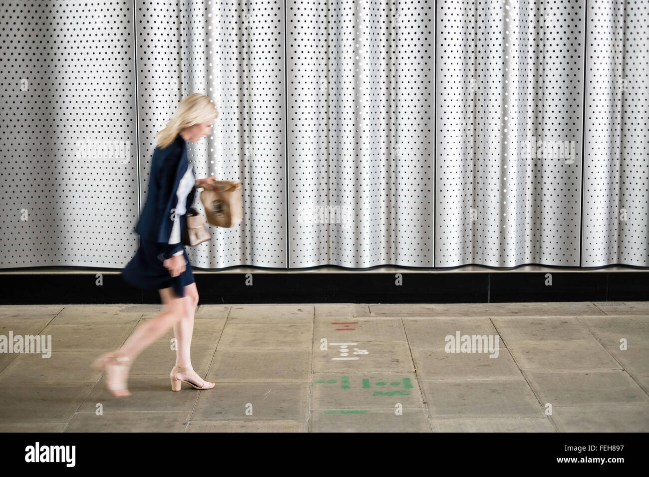 Woman walking sidewalk hi-res stock photography and images - Alamy