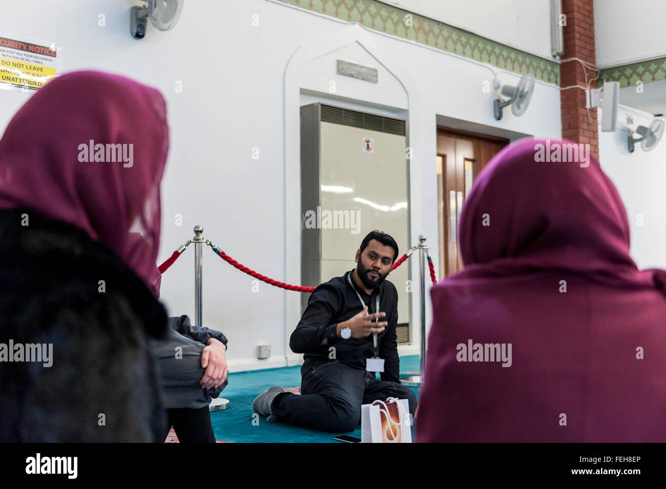 London, UK.  7 February 2016. A tour guide shows visitors the prayer room. The East London Mosque & London Muslim Centre, in the heart of Tower Hamlets, and home to the UK's largest Muslim community, opens its doors as part of 'Visit My Mosque Day', a national initiative facilitated by the Muslim Council of Britain, where mosques across the UK organise open days to allow the British public to see what goes on in a mosque and to understand its role in Muslim life.   Credit:  Stephen Chung / Alamy Live News Stock Photo