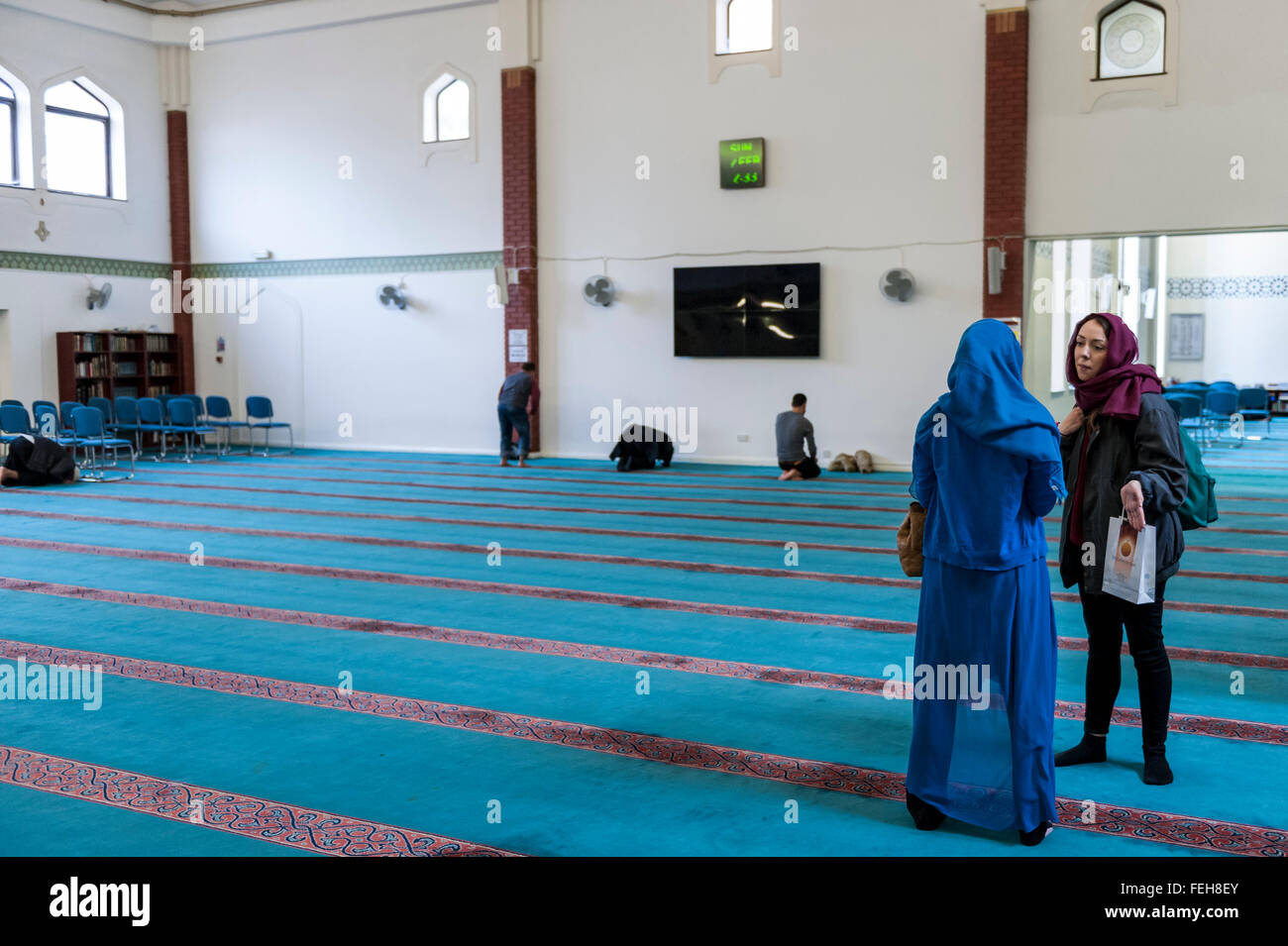 London, UK.  7 February 2016.  Visitors in the prayer room. The East London Mosque & London Muslim Centre, in the heart of Tower Hamlets, and home to the UK's largest Muslim community, opens its doors as part of 'Visit My Mosque Day', a national initiative facilitated by the Muslim Council of Britain, where mosques across the UK organise open days to allow the British public to see what goes on in a mosque and to understand its role in Muslim life.   Credit:  Stephen Chung / Alamy Live News Stock Photo