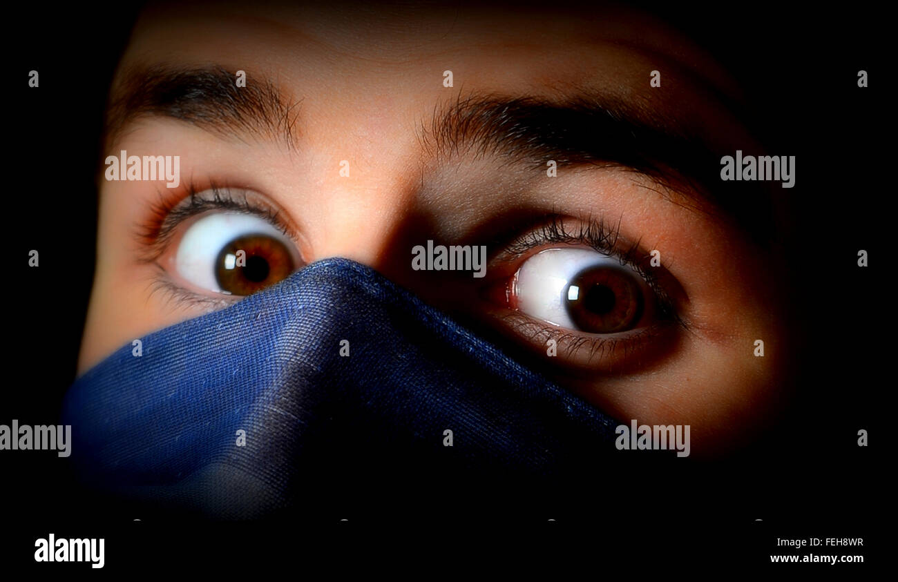 bright eyes of youth looking over a silk scarf Stock Photo Alamy