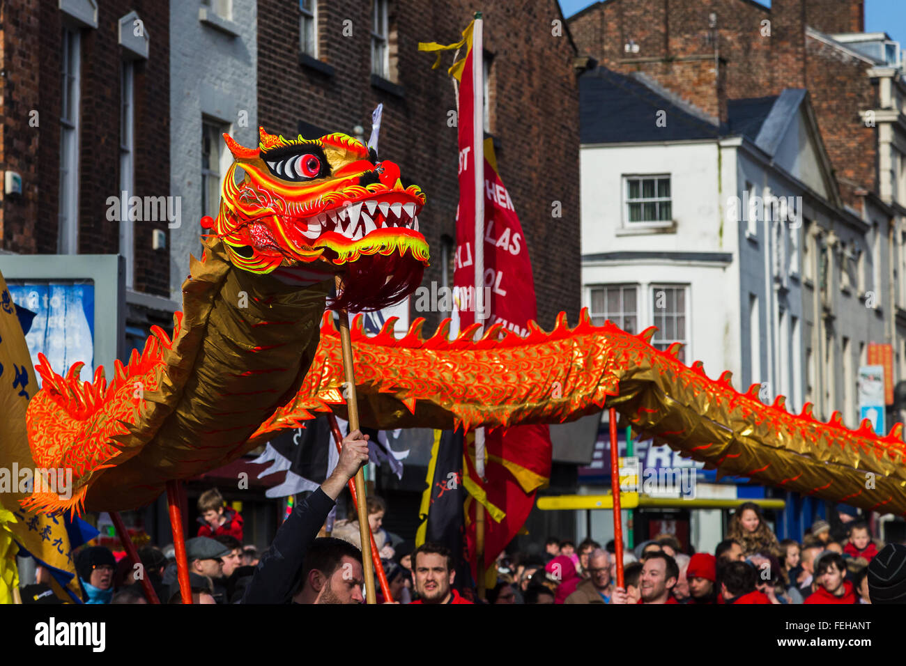 The vivid orange coloured dragon seen dancing around the main streets which make up Liverpool's Chinatown. Stock Photo