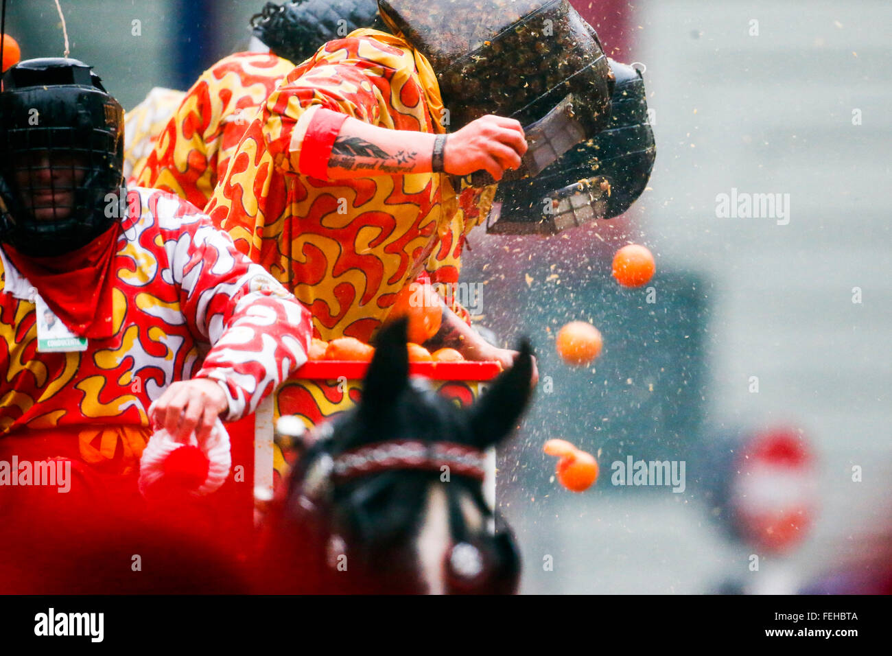 Ivrea, Italy. 07th Feb, 2016. Orange throwers on horse-drawn carts hit ...